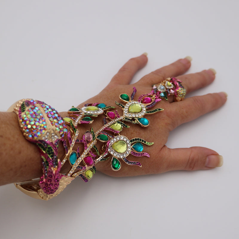 Vibrant And Colorful Statement Making Crystal Rhinestone 3D Peacock On Gold Tone Stretch Bangle Bracelet With Attached Ring Hand Chain Combination