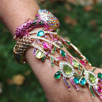 Vibrant And Colorful Statement Making Crystal Rhinestone 3D Peacock On Gold Tone Stretch Bangle Bracelet With Attached Ring Hand Chain Combination